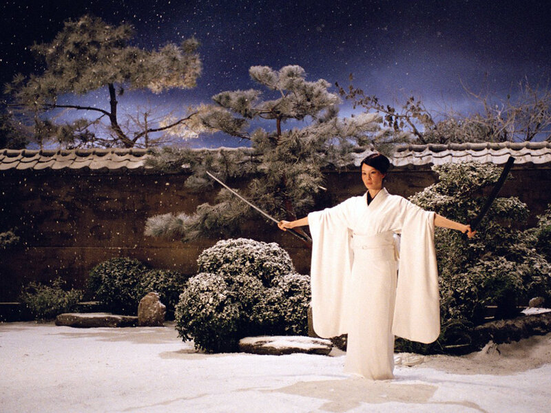 Woman in white kimono with sword