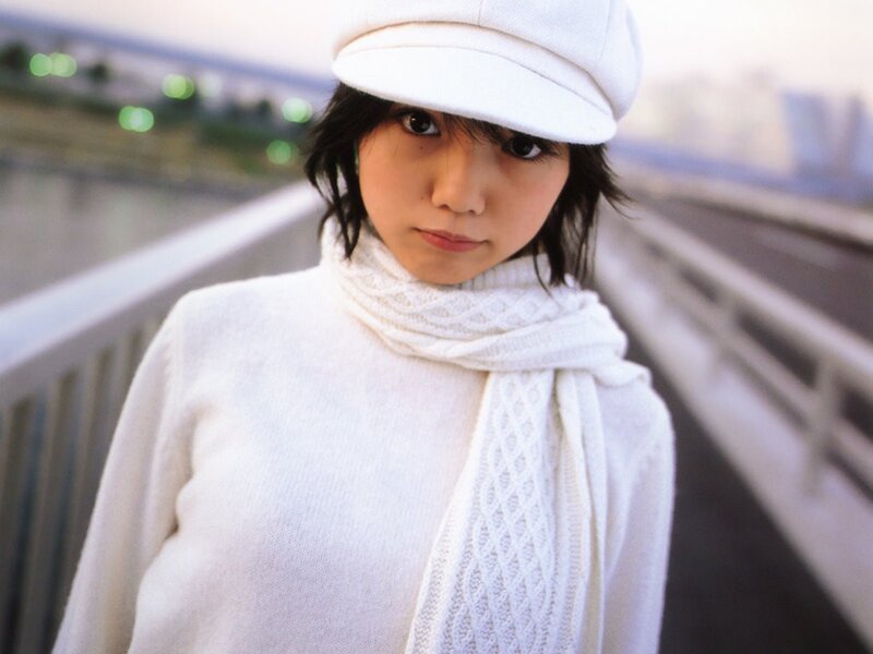woman in white on a bridge