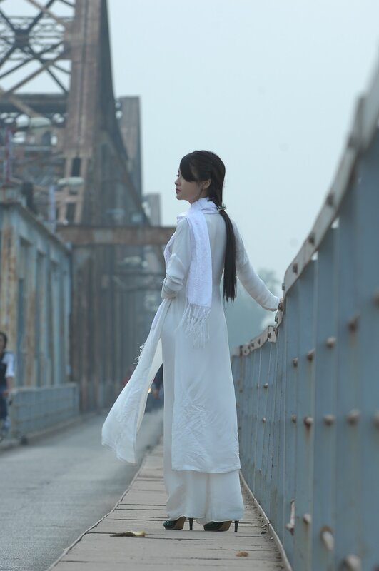 Woman in white on a bridge
