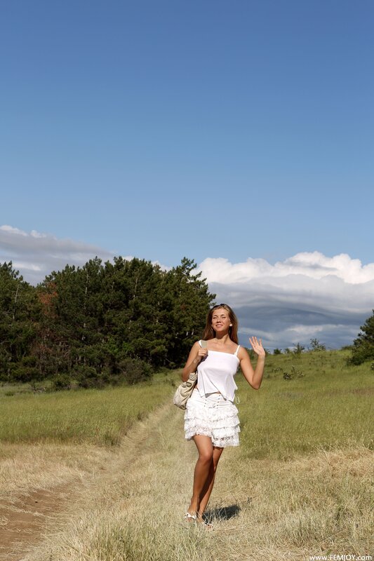 Woman in white on a grassy path