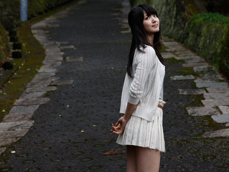 woman in white on a stone path