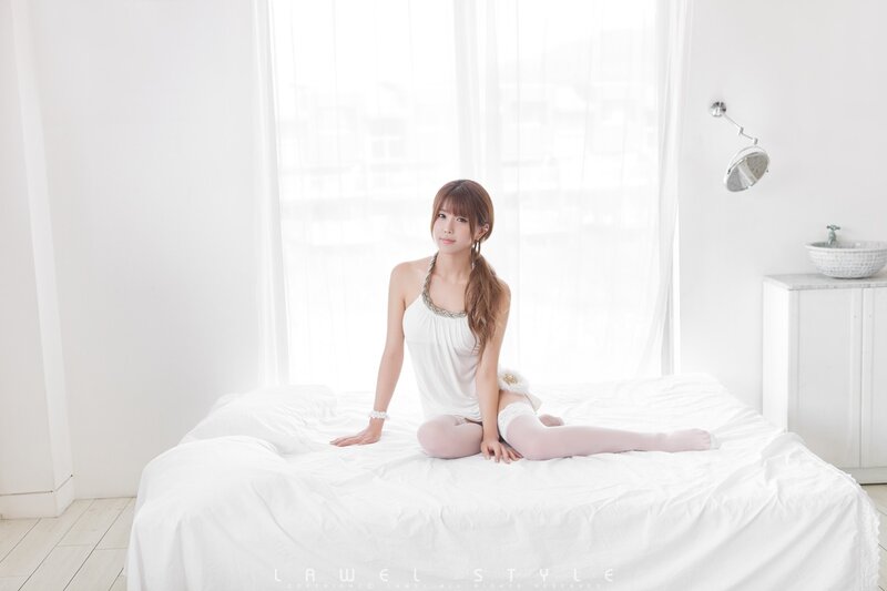 woman in white on bed