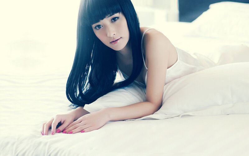 woman in white on bed