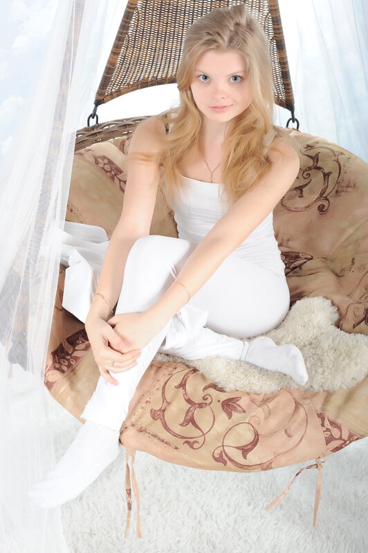 woman in white on wicker chair