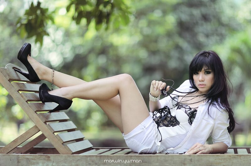 woman in white outfit on lounge chair