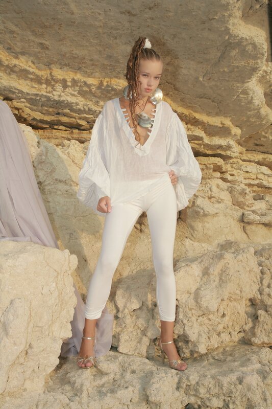 Woman in white outfit on rocks