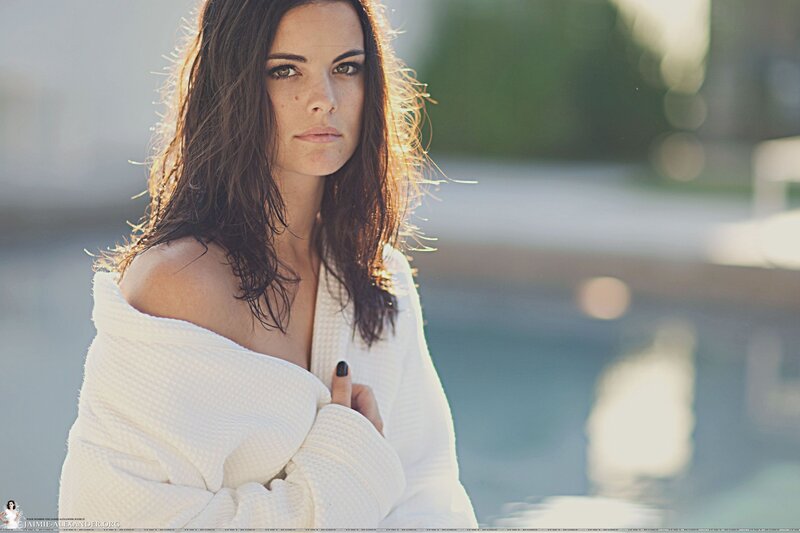 woman in white robe by pool