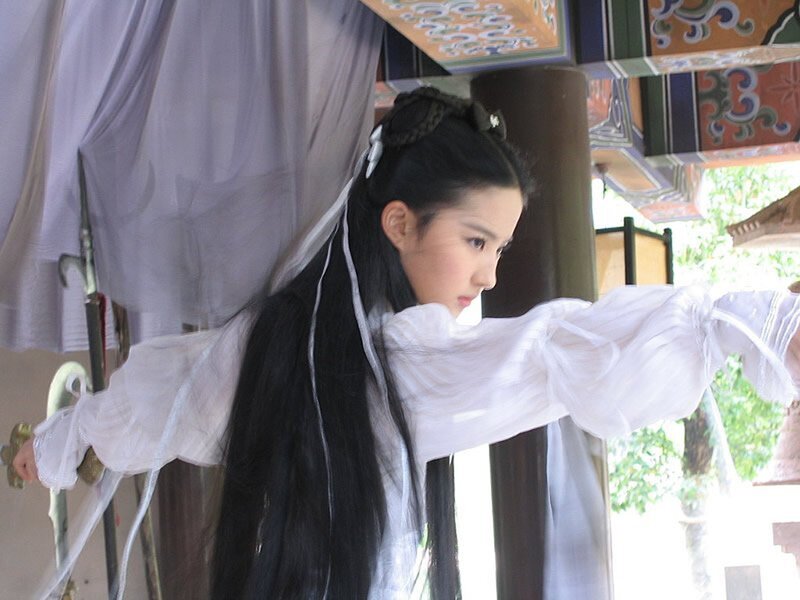 woman in white robe holding sword