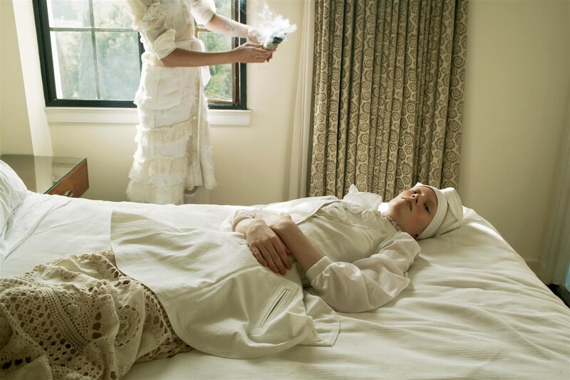 Woman in white robe on bed