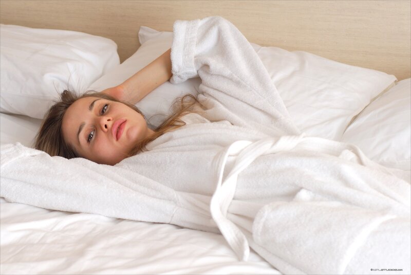 woman in white robe on bed