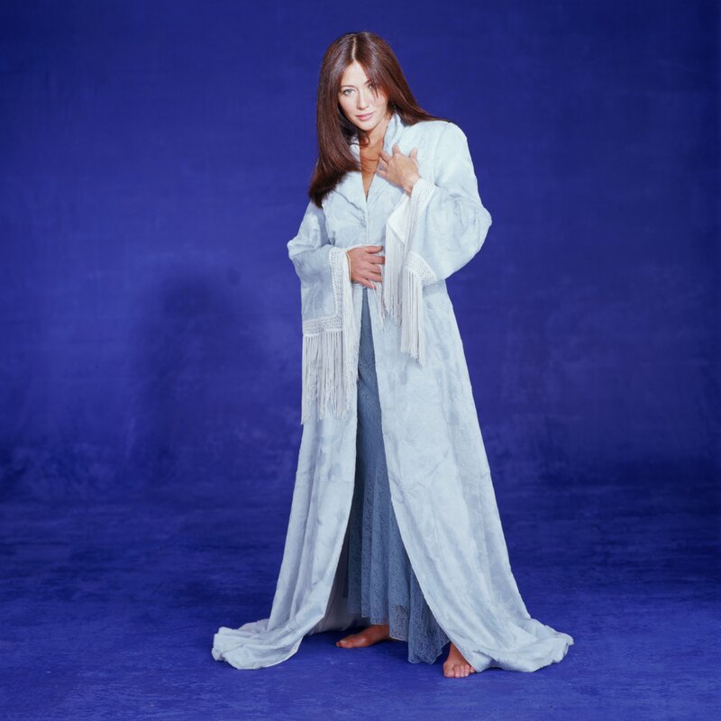 Woman in white robe on blue background