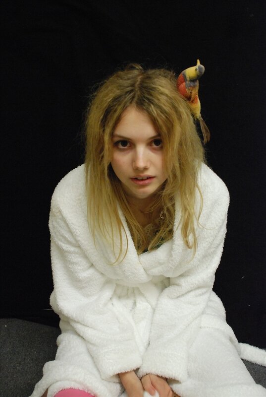woman in white robe with bird