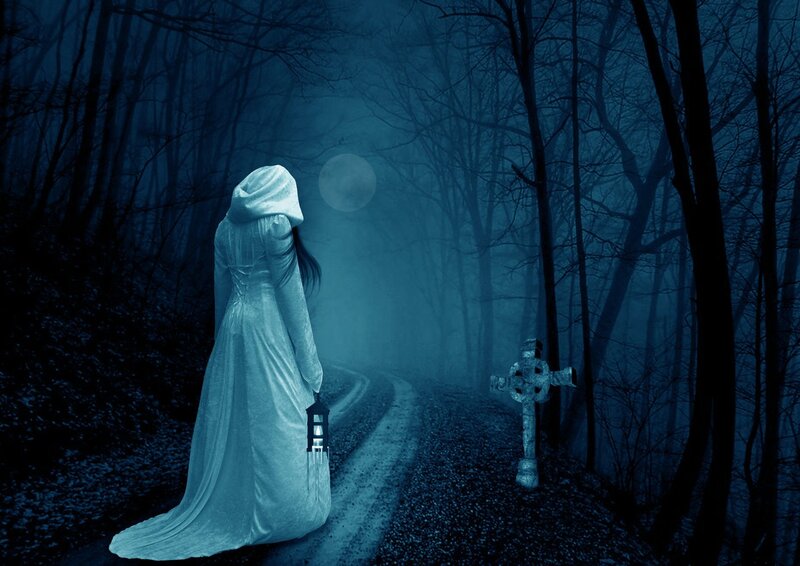 Woman in white robe with lantern