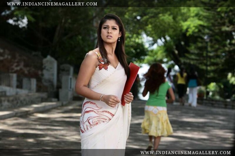 woman in white sari holding book