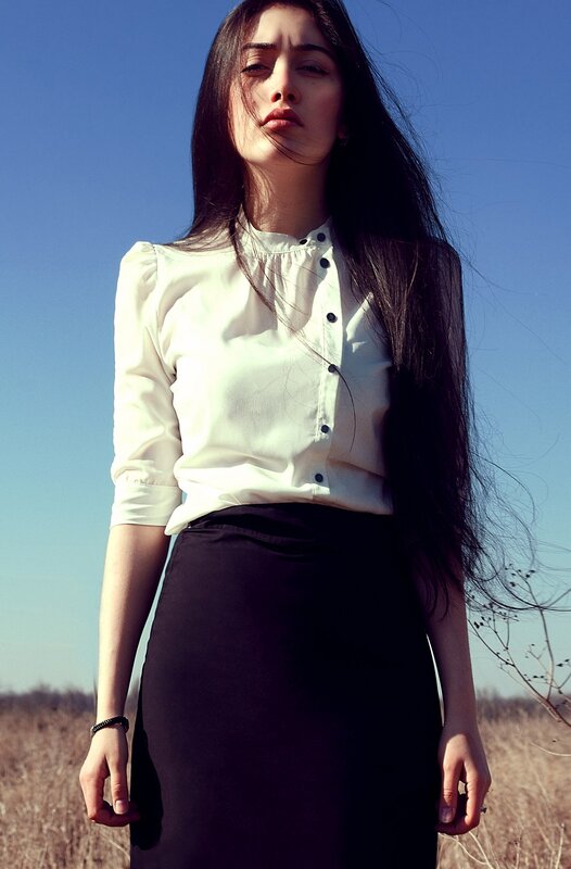 woman in white shirt and black skirt