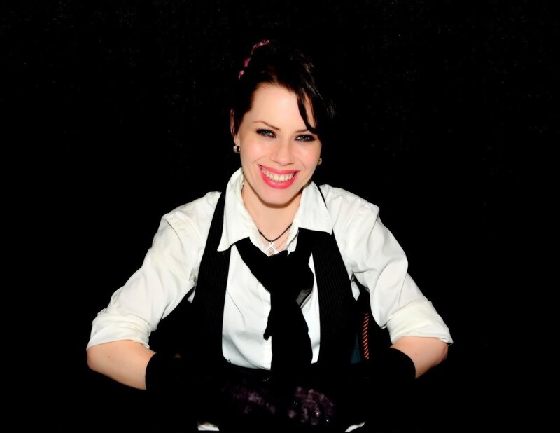 woman in white shirt and black vest
