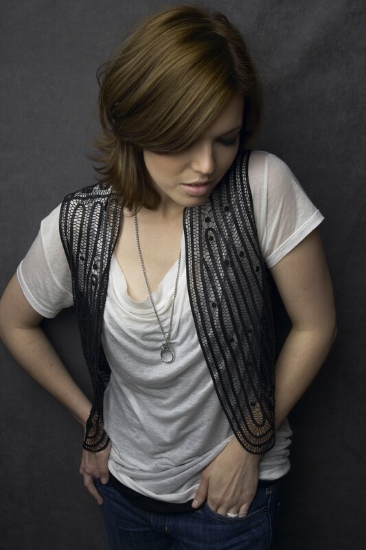 woman in white shirt and black vest