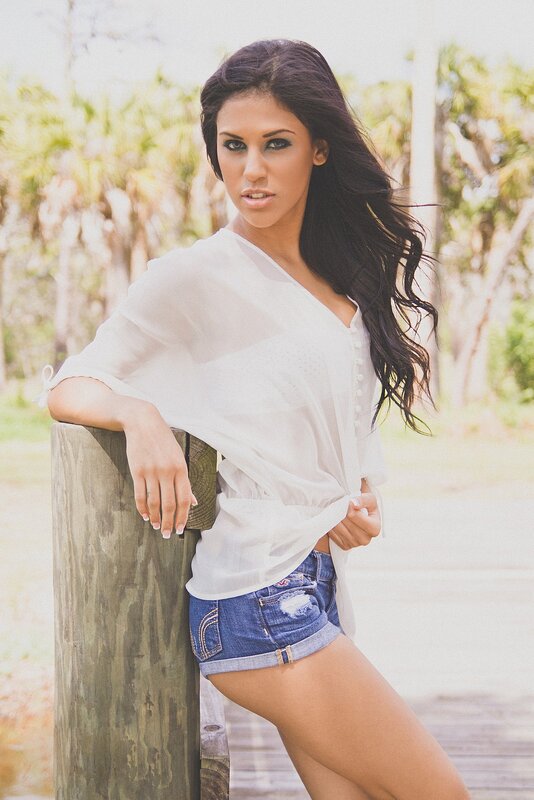 woman in white shirt and denim shorts