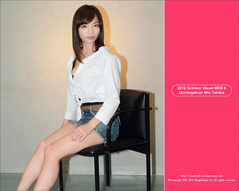 Woman in white shirt and denim shorts
