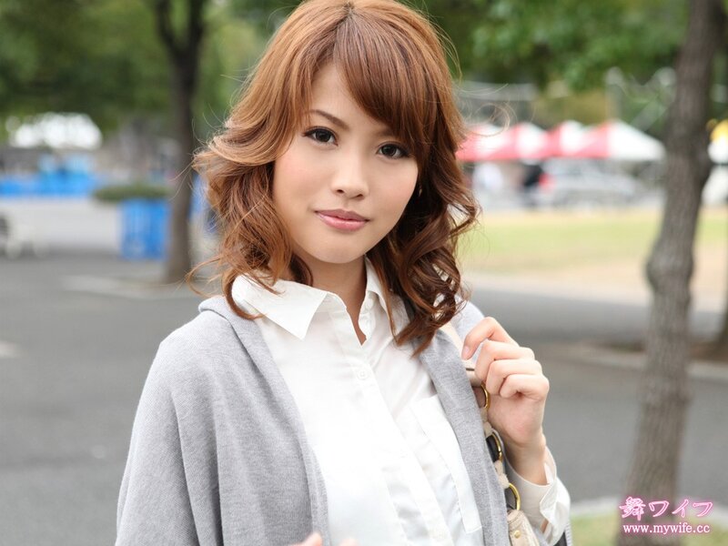 Woman in white shirt and grey cardigan