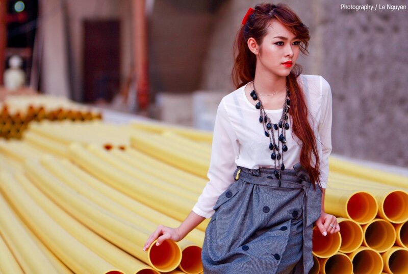 Woman in white shirt and grey skirt