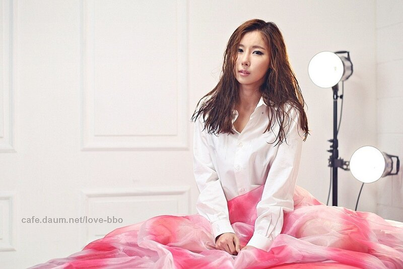 woman in white shirt and pink skirt