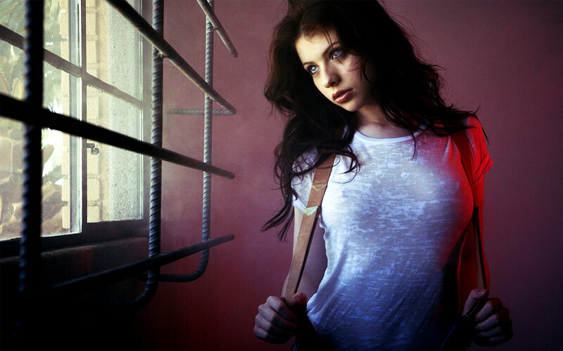 woman in white shirt by window