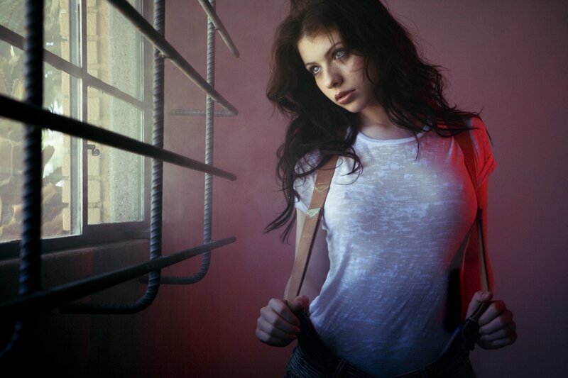 woman in white shirt by window