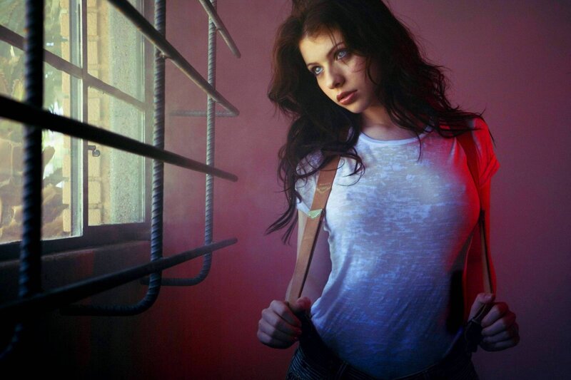 woman in white shirt by window