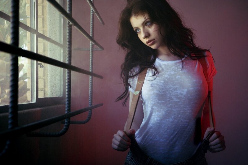woman in white shirt by window