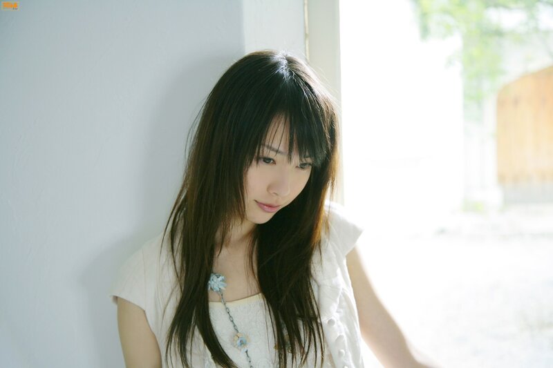 woman in white shirt by window