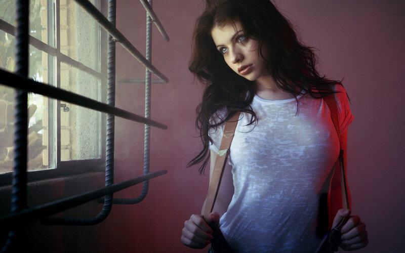 woman in white shirt by window