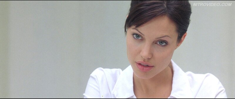 woman in white shirt looking at camera