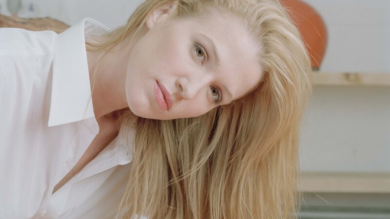woman in white shirt looking at camera