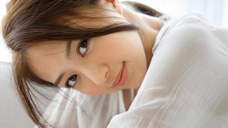 woman in white shirt looking at camera
