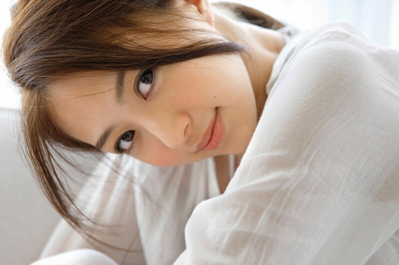 woman in white shirt looking at camera