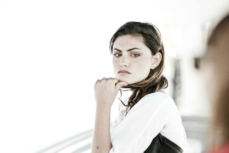 woman in white shirt looking at camera