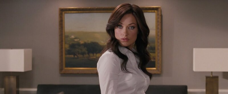 woman in white shirt looking back
