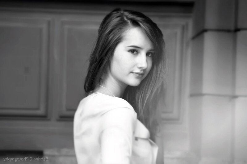 woman in white shirt looking back