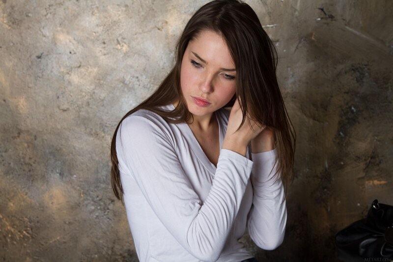 woman in white shirt looking down