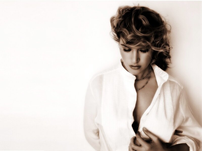 woman in white shirt looking down