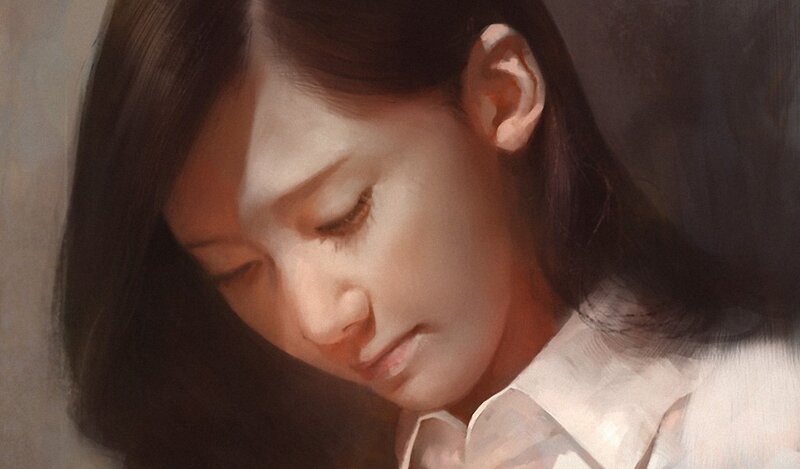 woman in white shirt looking down