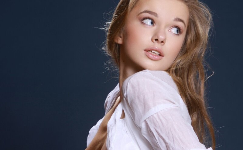woman in white shirt looking up
