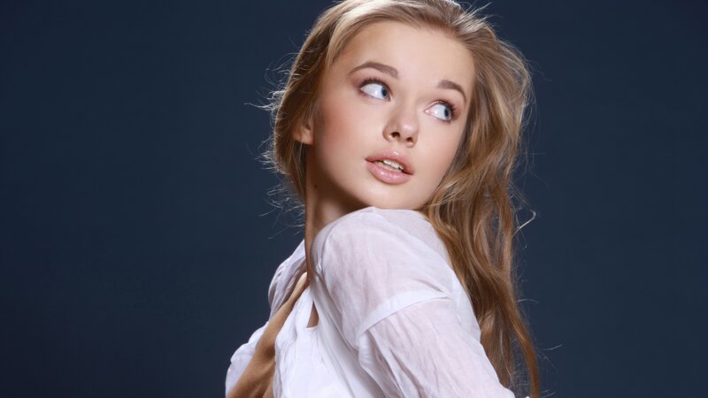 woman in white shirt looking up