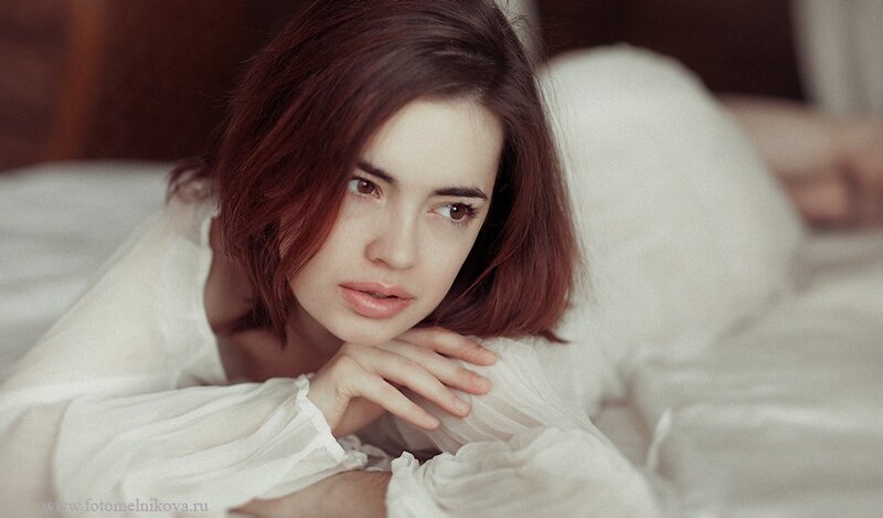 woman in white shirt lying down