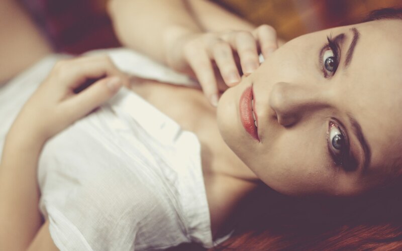 woman in white shirt lying down