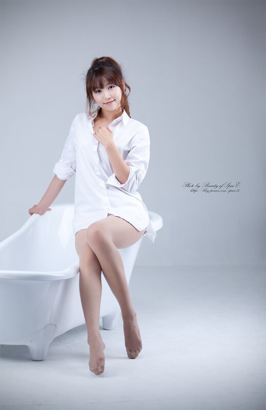 woman in white shirt sitting on bathtub