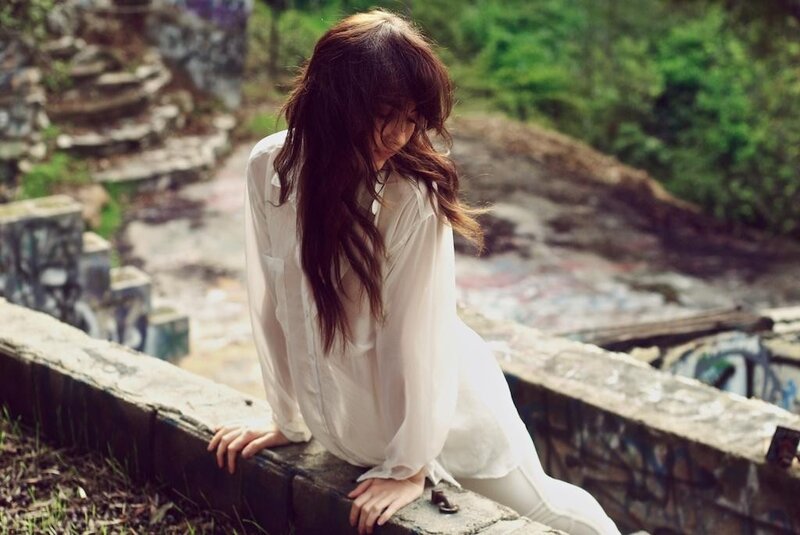 woman in white shirt sitting outside