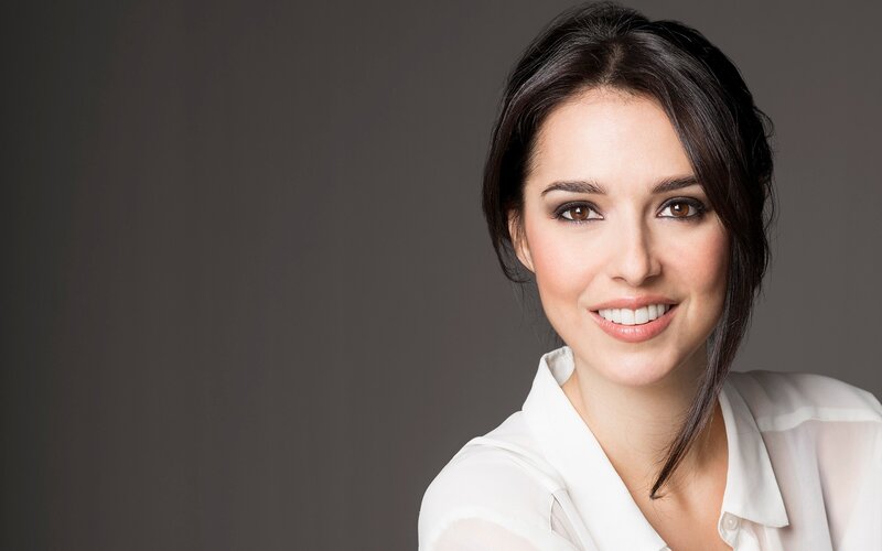 woman in white shirt smiling