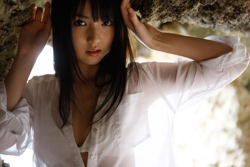 woman in white shirt under rock